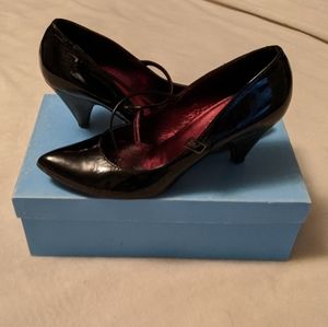 Patent black leather Mary-Jane heels.
